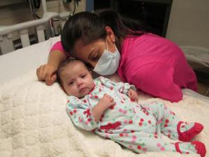 Alysia Padilla-Vacarro and daughter Evangelina on the day of her gene therapy treatment. Evangelina, now two years old, has had her immune system restored and lives a healthy and normal life. [Credit: UCLA Broad Center of Regenerative Medicine and Stem Cell Research.]