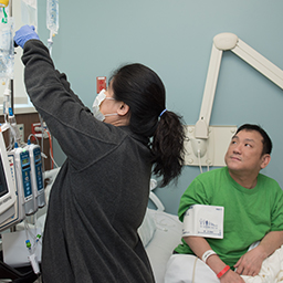 Aaron Kim with nurse. (City of Hope)