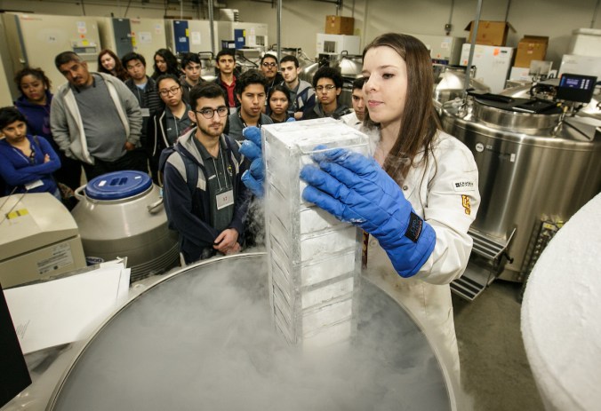 USC masters student Shantae Thornton shows students how cells are held in long term cold storage tanks at -195 celsius at the Stem Cell Day of Discovery event held at the USC Health Sciences Campus in Los Angeles, CA. February 4th, 2017. The event encourages students to learn more about STEM opportunities, including stem cell study and biotech, and helps demystify the fields and encourage student engagement. Photo by David Sprague