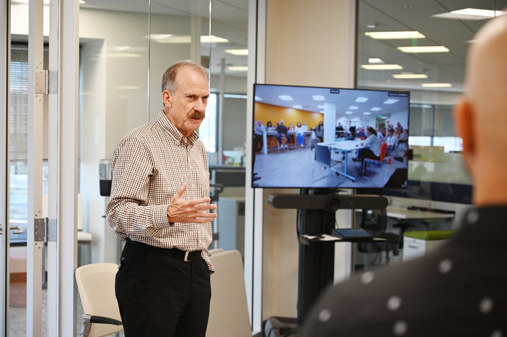 Image of CIRM CEO, Jonathan Thomas, leading a team meeting.