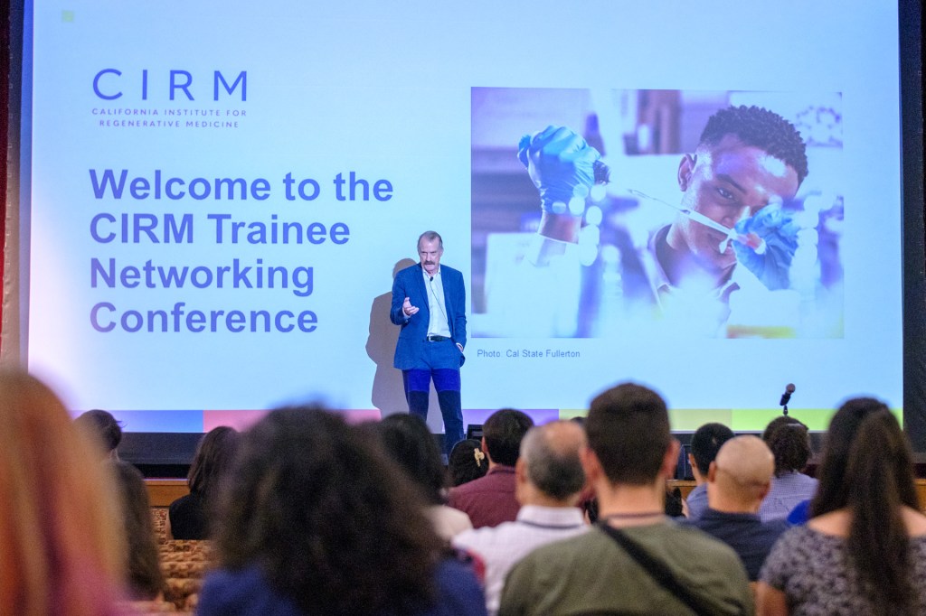 Image of CIRM CEO and President, Jonathan 'JT' Thomas speaking in front of CIRM Trainee Networking Conference attendees.