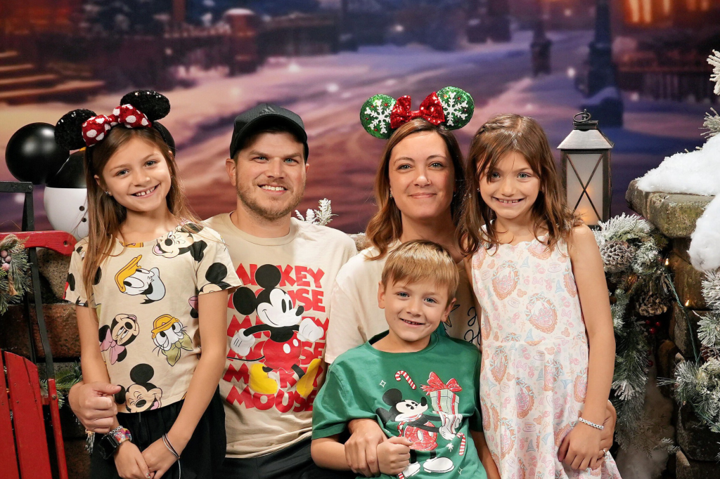 The Langenhop family posing for a picture at Disneyland during the winter holiday season.